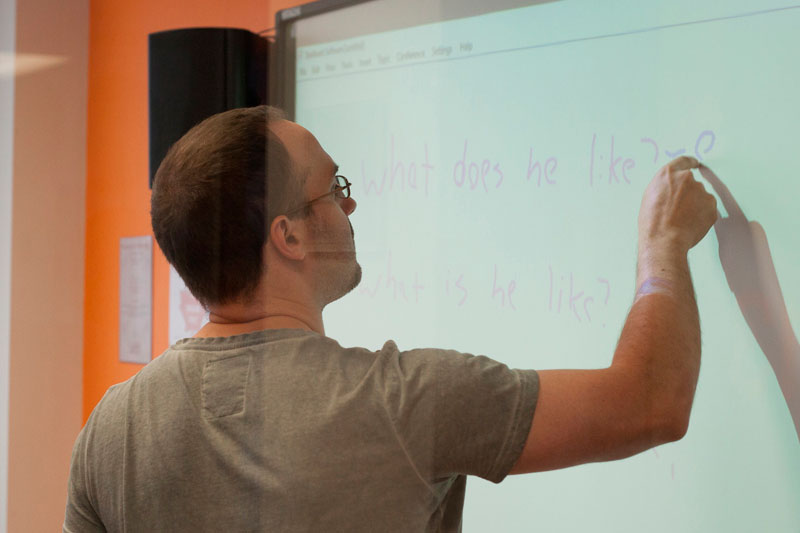 Teacher using interactive whiteboard whilst teaching English at EC Toronto