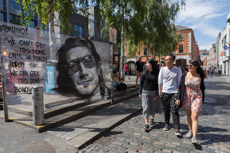 Young students walking and exploring Dublin's city center after their english course in EC 