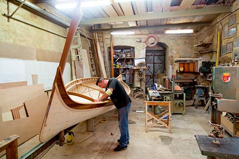 Finishing touches to a maltese luzzu, typical colorful maltese boat