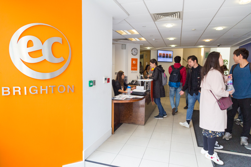 Students asking for directions at the EC Language School reception in Brighton