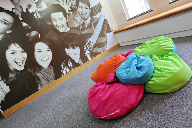 EC Brighton English School and it's colored bean bags and a black and white pictures of happy EC students