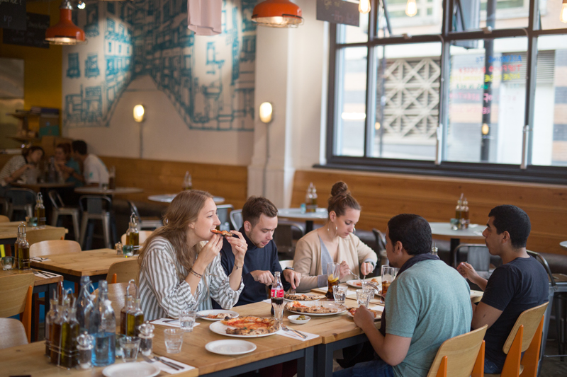 English students eating pizza in Brighton before joining their fellow students for the their English class