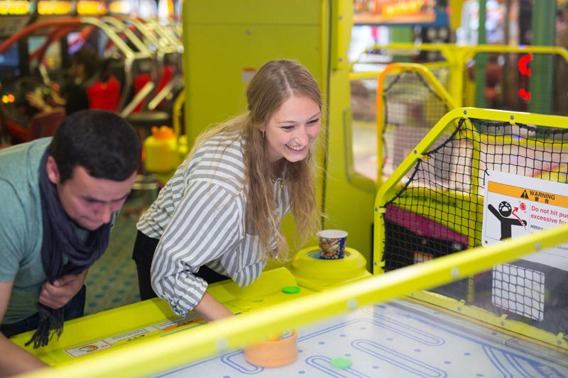 English students having fun at a games room in Brighton after their English class