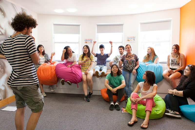 English lesson in Brighton at EC. Students having fun as they learn English in a bright colorful classroom.