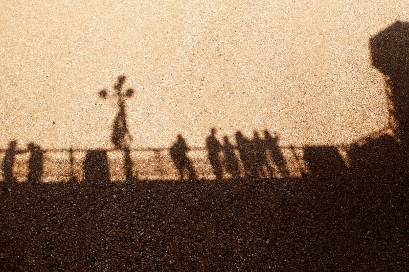 Shadows cast on the sandy beach of Brighton during sunset
