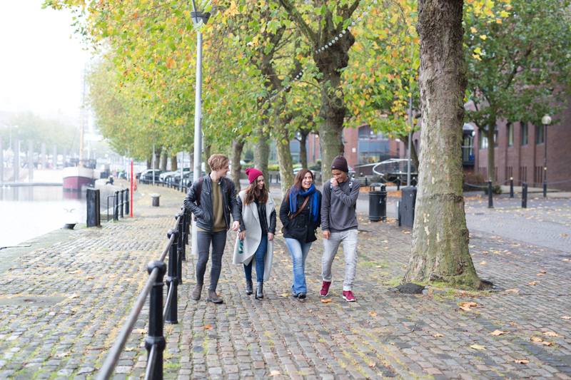 English students walking in Bristol by the water