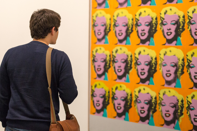 EC student admiring a modern art photograph, London