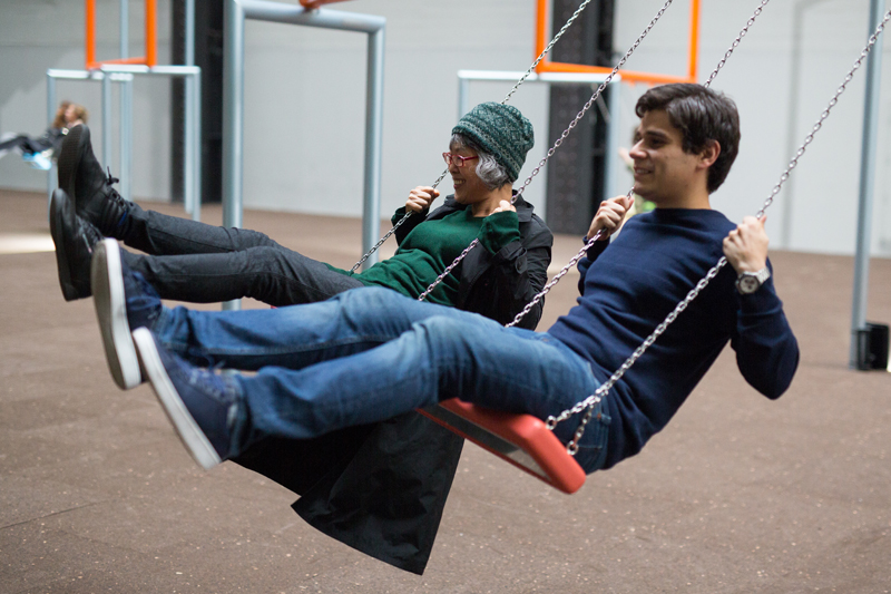 Two language students having some fun at Tate Modern's swings