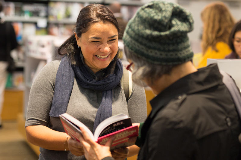 Two english students in London buying books to practice the language