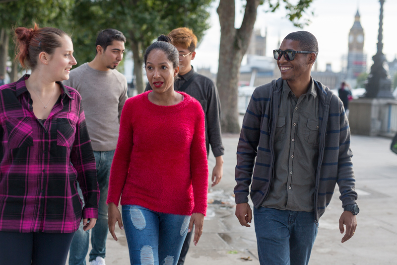 Students practicing English for their IELTS exam in London while exploring the city in their free time close to Big Ben Clock