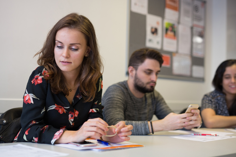 Student reading over her notes during an English course at EC London