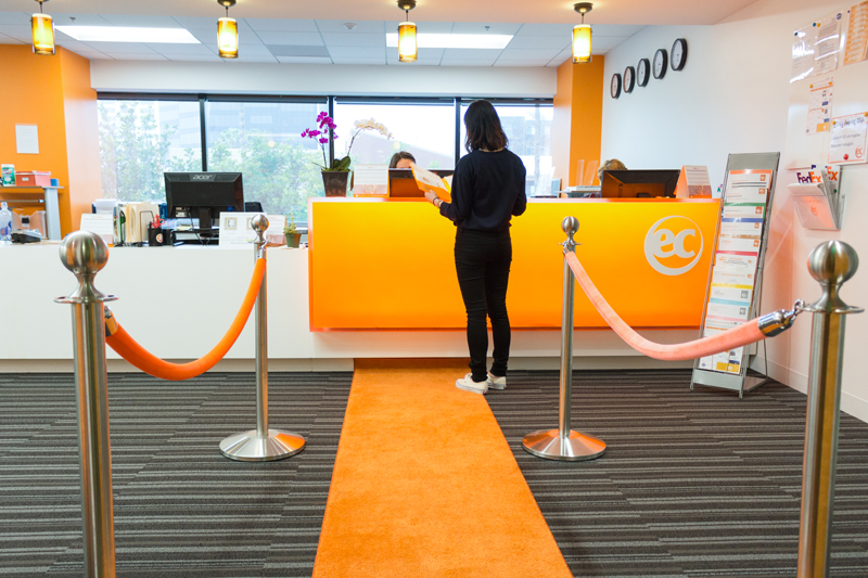 EC student asking for information on LA English courses at the reception of our EC Language School in Los Angeles