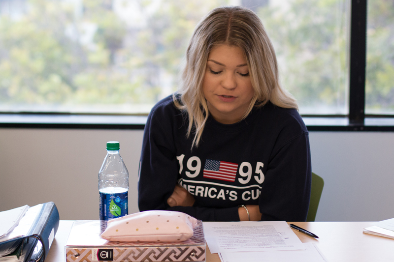 EC student reading a text from her English book during an English class at EC Los Angeles