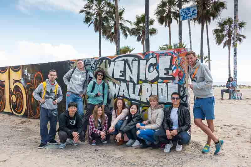 EC English students in Los Angeles taking a class picture near the beach